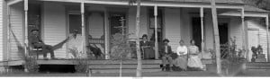 Allen Zerbe sitting on his ranch porch with friends and family